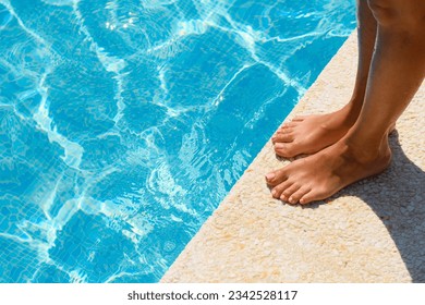 Women's feet by the pool on a summer day. Active recreation concept - Powered by Shutterstock