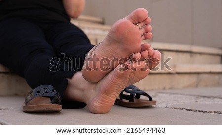 women's feet, crossed legs, foot rest from shoes in the heat