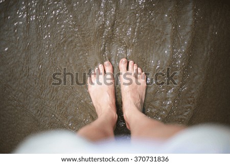 Women's feet in the water