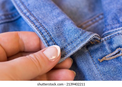 Women's Fingers Hold Denim So Close