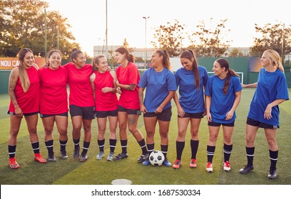 Womens Football Team Hugging After Training For Soccer Match On Outdoor Astro Turf Pitch