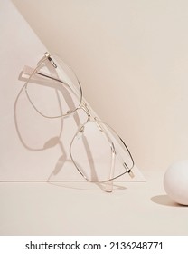 Women's Glasses On Beige Background. The Product Still A Life Concept. Minimal Still Life.