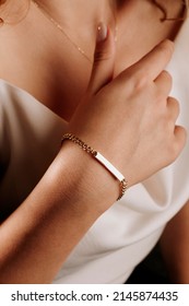 women's gold bracelet on the girl's hand, women's accessories, jewelry, gold bracelet with stones, women's jewelry, a girl with a bracelet on her arm, a bracelet with stones - Shutterstock ID 2145874435