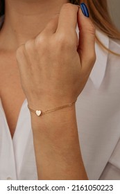 women's gold bracelet on the girl's hand, women's accessories, jewelry, gold bracelet with stones, women's jewelry, a girl with a bracelet on her arm, a bracelet with stones - Shutterstock ID 2161050223