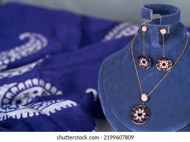 Women's Gold Necklace And Earrings Silk Blue Background, Close-up. Luxury Female Jewelry