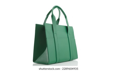 Women's green handbag on a white background with reflection