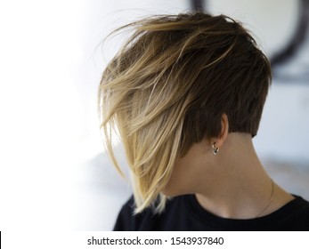 Women's haircut with active texture and disconnected zones.