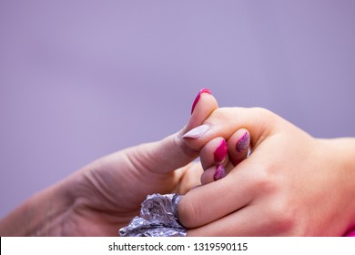 Women's Hand With Aluminum Foil On Nails In Nail Salon.