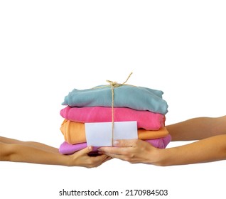 Women's hand give a stack of clothes to children's hands. Helping the poor, helping those in need. Clothes Donation, Renewable Concept. Preparing Garment at Home before Donate. Help from volunteers - Shutterstock ID 2170984503