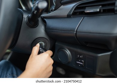 Women's hand turns the key to the car. Hands of the girl to take the keys to start the car engine. Key to start the car engine - Powered by Shutterstock