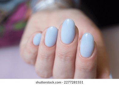 Women's hands and blue nails  Nail design  manicure and gel polish 