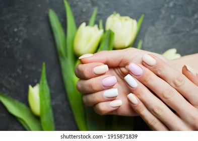 Women's Hands With Colorful Pattern On The Nails. 2021 Colors Trend. Top View. Place For Text. Spring Nails Concept.