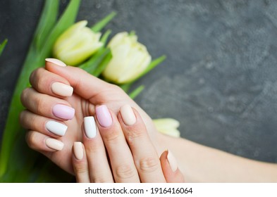 Women's Hands With Colorful Pattern On The Nails. 2021 Colors Trend. Top View. Place For Text. Spring Nails Concept.