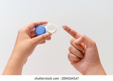 Women's hands with contact lenses and a container for contact lenses. Top view. Close-up