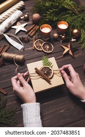 Women's Hands Decorate Christmas Gift Box With Eco-friendly Natural Decorations. Creative Diy Hobby.