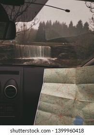 Women's Hands Explore The Paper Map, Laying It In The Car