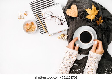 Women's Hands Hold A Cup Of Coffee  Wrapped In Scarf  On A Warm Plaid. Autumn Or Winter Concept.  Flat Lay, Top View