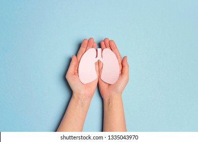 Women's Hands Hold A Lungs Symbol On Blue Background. World Tuberculosis Day. Healthcare, Medicine, Hospital,  Diagnostic, Internal Donor Organ.