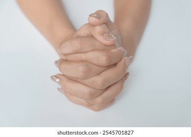 women's hands interlocking their fingers - Powered by Shutterstock