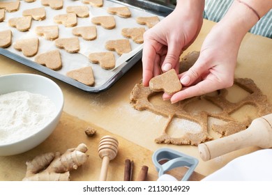 Women's Hands Lay Out Cookies On A Baking Sheet. The Process Of Making Holiday Cookies For Valentine's Day. Home Baking With Love. Family Care Concept.