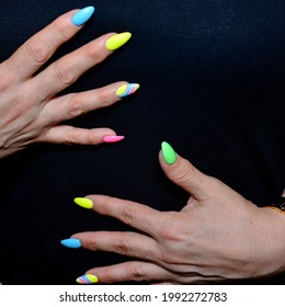 Women's Hands Of A Mature Woman With A Manicure Of Different Colors 