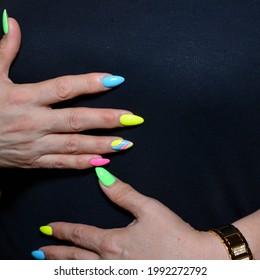 Women's Hands Of A Mature Woman With A Manicure Of Different Colors 