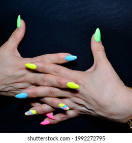 Women's Hands Of A Mature Woman With A Manicure Of Different Colors 