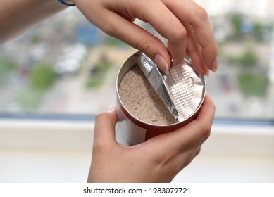 Women's Hands Opening The Lid Of A Jar Of Instant Coffee With Milk