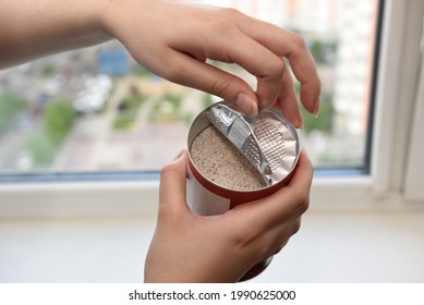 Women's Hands Opening The Lid Of A Jar Of Instant Coffee With Milk