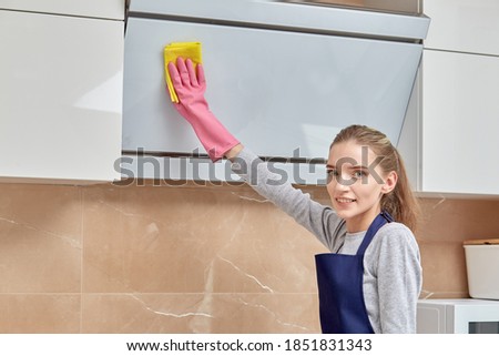 Women's hands in pink gloves doing cleaning in the kitchen. Modern kitchen. Performing a home routine. Cleanliness in the house.