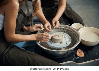 Women's hands potters making ceramic product on the pottery wheel - Powered by Shutterstock