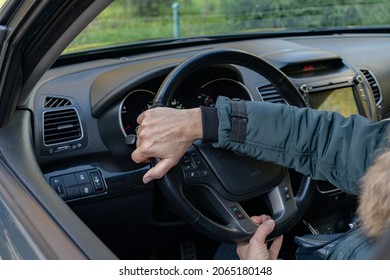 Women's Hands Turn The Steering Wheel In The Car.