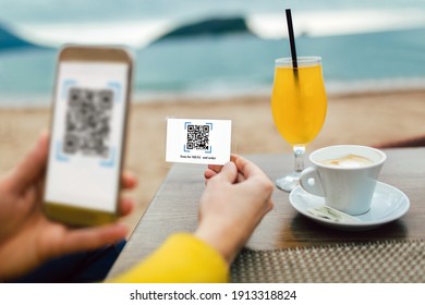 Women's Hands Are Using The Phone To Scan The Qr Code To Select Menu. 