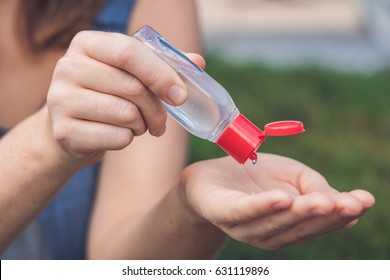 Women's hands using wash hand sanitizer gel pump dispenser. - Powered by Shutterstock