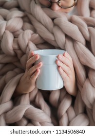 Women's Hands In A Warm Soft Blanket With A Mug Of Coffee. Mockup For Winter Gifts Design.