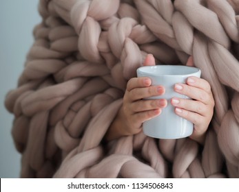 Women's Hands In A Warm Soft Blanket With A Mug Of Coffee. Mockup For Winter Gifts Design.