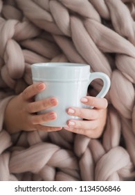 Women's Hands In A Warm Soft Blanket With A Mug Of Coffee. Mockup For Winter Gifts Design.