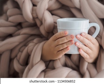 Women's Hands In A Warm Soft Blanket With A Mug Of Coffee. Mockup For Winter Gifts Design.