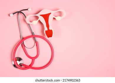 Women's Health Awareness Concept. Uterus Symbol With Stethoscope On Pink Background. Diagnostic And Research Women's Reproductive System.