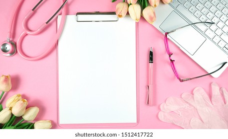 Women's Health Issues concept on pink doctor's desk flat lay overhead with negative copy space.
