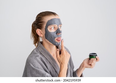 Womens Health. Spa And Wellness. Happy Funny Woman Applying Face Mask And Tasting It