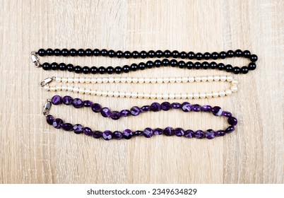 Women's jewelry, necklace, beads. Jewelry from natural stones on a light background.