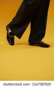 Women's Lacquered Black Loafers Close-up On A Yellow Background. Women's Loafers. Style And Fashion