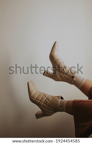 Women's legs in socks and boots in the air.