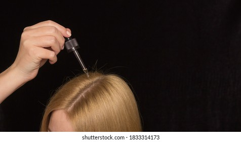 Women's Light Red Hair On A Black Background And A Pipette With Cosmetic Oil. Hair And Scalp Care.