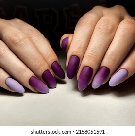 Women's manicure and purple gradient design  Beautiful lilac  purple gradient the nails  Extension long round nails and purple design 