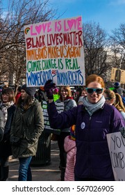 Women's March Denver Jan 21, 2017 An individual in the crowd with a sign reading "Love is love, black lives matter, immigrants make USA great, climate change is real, women's rights are human rights"