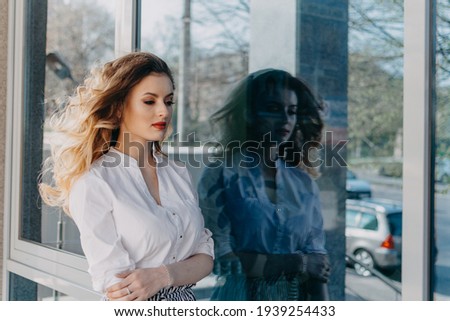 Womens Mental Health. Anxiety Panic Disorders. Bipolar Disorder. Outdoor portrait of Young sad woman and her dark reflection in the mirror window