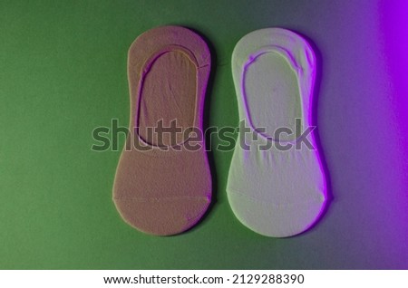 Women's multi-colored socks in colored light