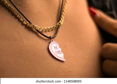 Women`s necklace in the shape of a broken heart.